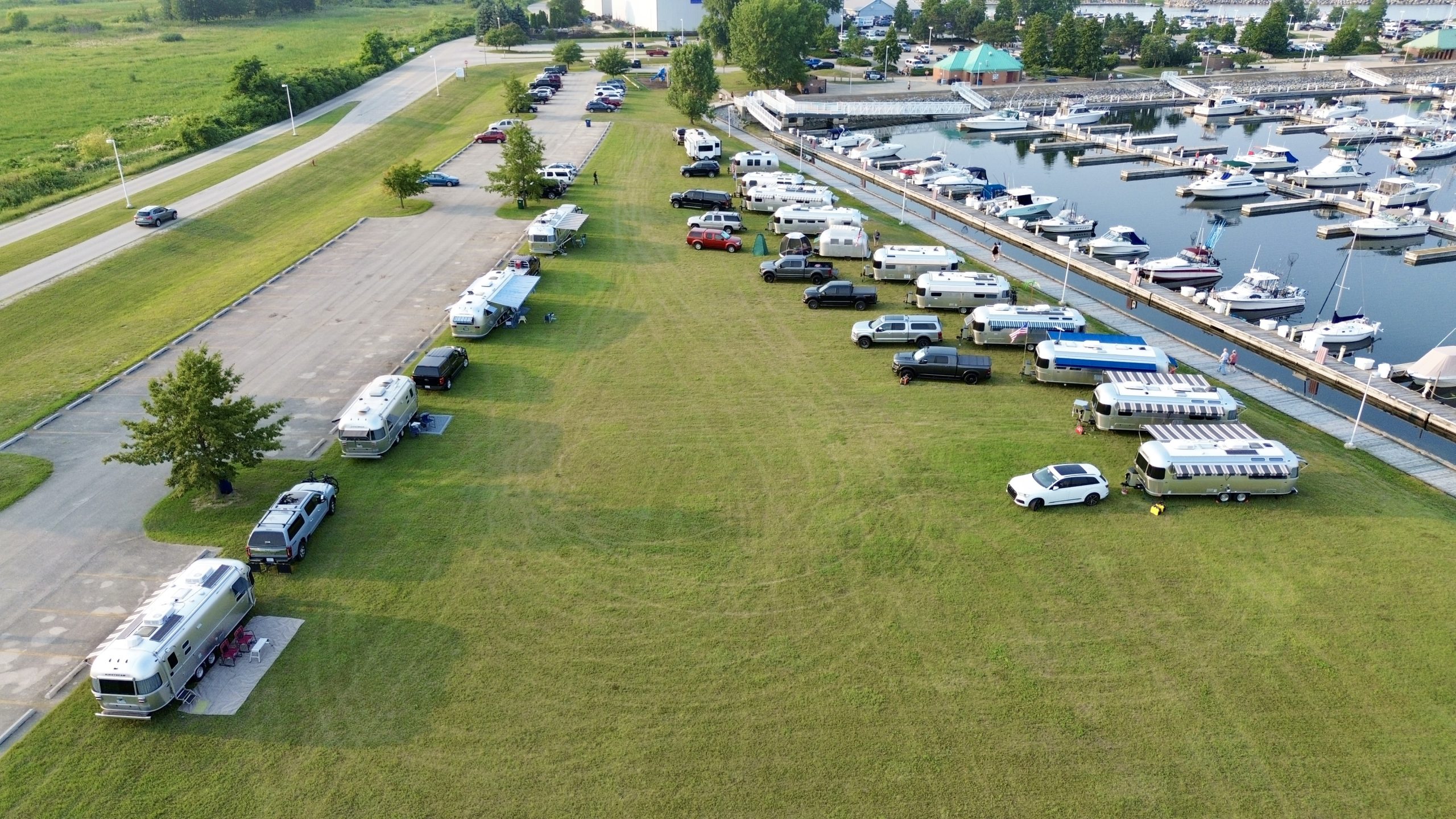 Airstream trailers gathered beside North Point Marina on a sunny day.