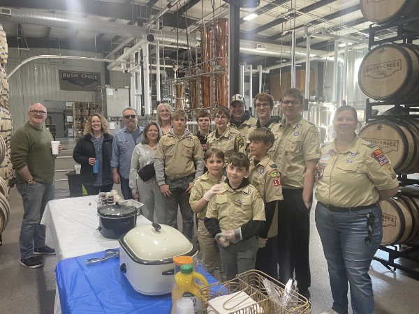 Boy Scouts and adults gathered for breakfast inside the Rush Creek Distilling production area.
